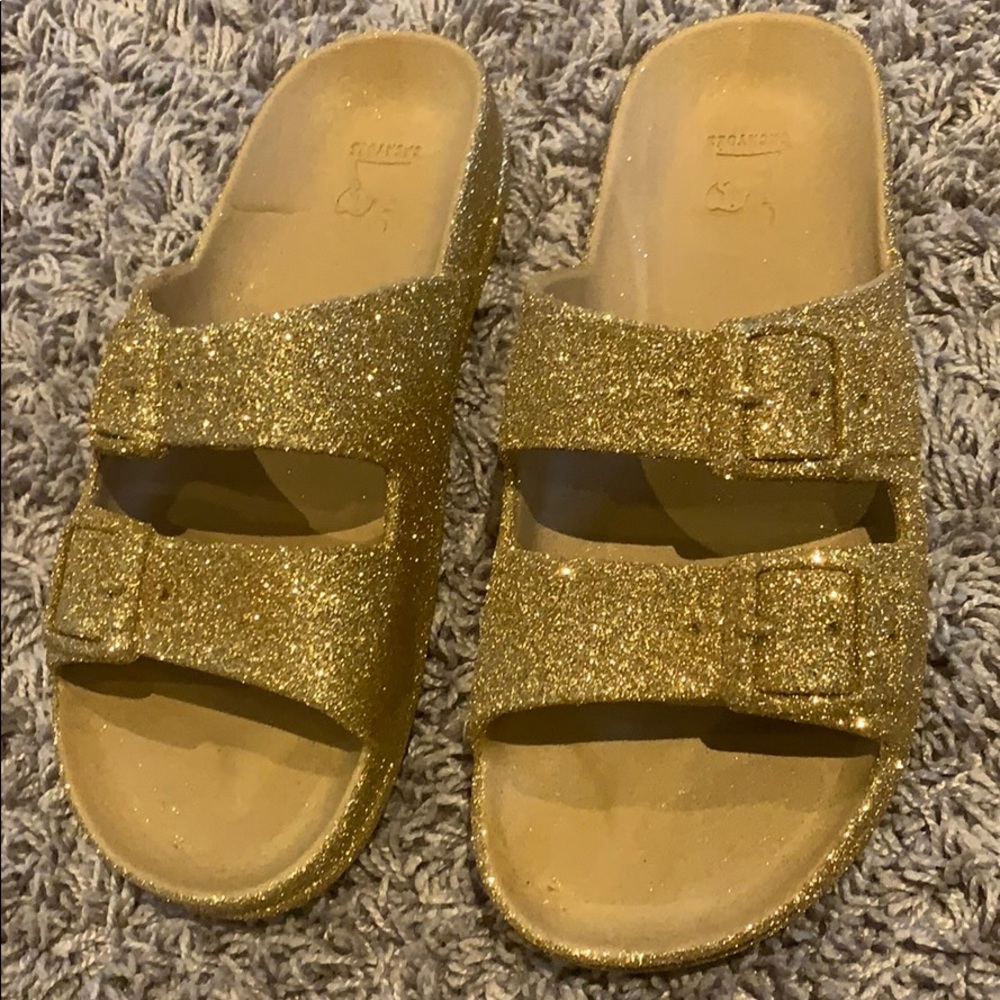 a pair of gold, glittery sandals